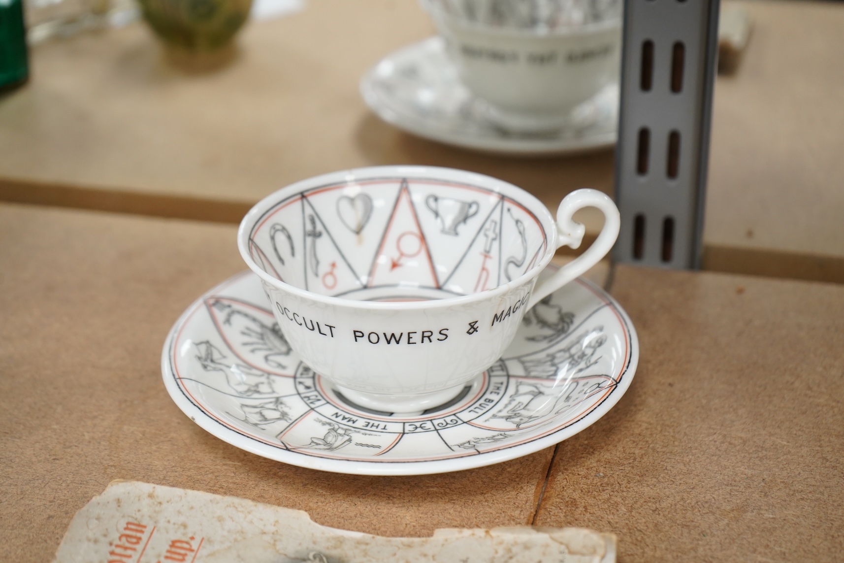 A Royal Doulton 'The Egyptian Divining cup and saucer', with booklet, numbered RN543665
